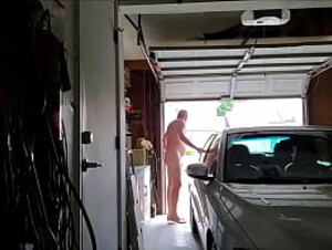 Old man naked in garage daytime door open cars drive by