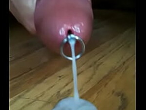 Chris X masturbates his cock with a flow thru urethral insert and spits a huge load