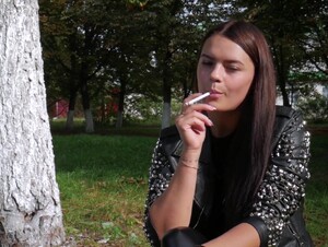 Pretty Faced Asya Is Smoking A Cigarette Outdoors