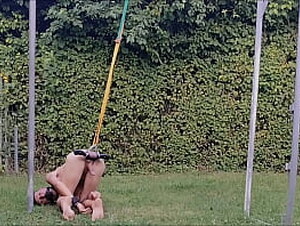 naked slave pig exposed outdoor, handcuffed, swings around with testicles in humbler, stretched balls, BDSM CBT